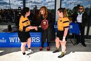 26 April 2025; Ashbourne captains Keela Walsh Fagherazzi, left, and Laura Scuffil are presented the Cusack Plate by Carol Cusack, mother of Paul, after the Cusack Plate Final match between Longford and Ashbourne during the Leinster Rugby Girls Finals Day at Mullingar RFC in Mullingar, Westmeath. Photo by Ben McShane/Sportsfile