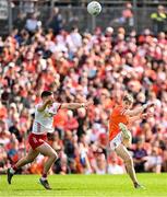 26 April 2025; Andrew Murnin of Armagh kicks under pressure from Tyrone's Niall Devlin during the Ulster GAA Football Senior Championship semi-final match between Armagh and Tyrone at St Tiernach's Park in Clones, Monaghan. Photo by Seb Daly/Sportsfile