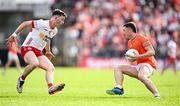 26 April 2025; Oisin Conaty of Armagh in action against Aidan Clarke of Tyrone during the Ulster GAA Football Senior Championship semi-final match between Armagh and Tyrone at St Tiernach's Park in Clones, Monaghan. Photo by Seb Daly/Sportsfile