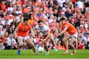 26 April 2025; Darragh Canavan of Tyrone in action against Armagh players Callum O'Neill, left, and Darragh McMullan during the Ulster GAA Football Senior Championship semi-final match between Armagh and Tyrone at St Tiernach's Park in Clones, Monaghan. Photo by Seb Daly/Sportsfile