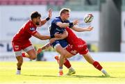 26 April 2025; Fintan Gunne of Leinster is tackled by Johnny Williams and Taine Plumtree of Scarlets during the United Rugby Championship match between Scarlets and Leinster at Parc Y Scarlets in Swansea, Wales. Photo by Chris Fairweather/Sportsfile