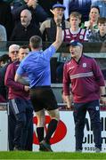 26 April 2025; Referee James Owens issues a yellow card to Galway manager Micheál Donoghue before the start of the second half  during the Leinster GAA Hurling Senior Championship Round 2 match between Offaly and Galway at Glenisk O’Connor Park in Tullamore, Offaly. Photo by Ray McManus/Sportsfile
