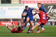 26 April 2025; Liam Turner of Leinster is tackled by Ellis Mee and Jamie Osborne of Leinster during the United Rugby Championship match between Scarlets and Leinster at Parc Y Scarlets in Swansea, Wales. Photo by Chris Fairweather/Sportsfile