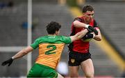 27 April 2025; Pat Havern of Down is tackled by Finnbarr Roarty of Donegal during the Ulster GAA Football Senior Championship semi-final match between Down and Donegal at St Tiernach's Park in Clones, Monaghan. Photo by Ben McShane/Sportsfile
