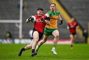 27 April 2025; Daniel Guinness of Down is tackled by Ciaran Thompson of Donegal during the Ulster GAA Football Senior Championship semi-final match between Down and Donegal at St Tiernach's Park in Clones, Monaghan. Photo by Ben McShane/Sportsfile
