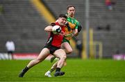 27 April 2025; Daniel Guinness of Down is tackled by Ciaran Thompson of Donegal during the Ulster GAA Football Senior Championship semi-final match between Down and Donegal at St Tiernach's Park in Clones, Monaghan. Photo by Ben McShane/Sportsfile