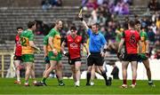 27 April 2025; Referee Joe McQuillan issues a yellow card to Michael Murphy of Donegal, second from left, during the Ulster GAA Football Senior Championship semi-final match between Down and Donegal at St Tiernach's Park in Clones, Monaghan. Photo by Ben McShane/Sportsfile