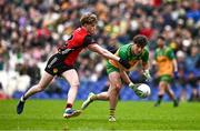 27 April 2025; Dáire Ó Baoill of Donegal is tackled by Patrick McCarthy of Down during the Ulster GAA Football Senior Championship semi-final match between Down and Donegal at St Tiernach's Park in Clones, Monaghan. Photo by Ben McShane/Sportsfile