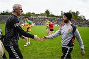 27 April 2025; Donegal manager Jim McGuinness, left, and Down manager Conor Laverty shake hands after the Ulster GAA Football Senior Championship semi-final match between Down and Donegal at St Tiernach's Park in Clones, Monaghan. Photo by Ben McShane/Sportsfile