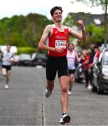 27 April 2025; Dylan Casey of Ennis Track AC crosses the finish line to win the men's senior relay during the 123.ie National Road Relay Championships in Raheny, Dublin. Photo by Tyler Miller/Sportsfile