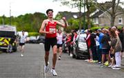 27 April 2025; Dylan Casey of Ennis Track AC crosses the finish line to win the men's senior relay during the 123.ie National Road Relay Championships in Raheny, Dublin. Photo by Tyler Miller/Sportsfile