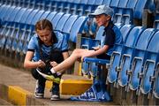 27 April 2025; Thirteen year old Brooke Flood ties the laces of Jace Gannon, 7, before the Leinster GAA Football Senior Championship semi-final match between Dublin and Meath at Laois Hire O'Moore Park in Portlaoise, Laois. Photo by Ray McManus/Sportsfile