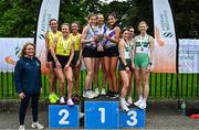 27 April 2025; Athletics Ireland president Bríd Golden, left, with senior women's medalists Dundrum South Dublin AC, Dublin, gold, UCD AC, Dublin, silver and Raheny Shamrock AC, Dublin, bronze, during the 123.ie National Road Relay Championships in Raheny, Dublin. Photo by Tyler Miller/Sportsfile