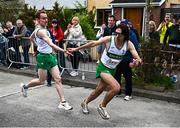 27 April 2025; Cillian O'Leary of Raheny Shamrock AC takesover from team-mate Mark Kirwan whilst competing in the men's masters 35+ event during the 123.ie National Road Relay Championships in Raheny, Dublin. Photo by Tyler Miller/Sportsfile