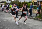 27 April 2025; Lee Duddy of Clonliffe Harriers AC, Dublin, takes over from team-mate Evan Lynch whilst competing in the senior men's event during the 123.ie National Road Relay Championships in Raheny, Dublin. Photo by Tyler Miller/Sportsfile