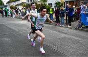 27 April 2025; Oisin Davis of Craughwell AC, Galway, takes over from team-mate William Fitzgerald whilst competing in the senior men's event during the 123.ie National Road Relay Championships in Raheny, Dublin. Photo by Tyler Miller/Sportsfile