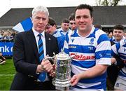 27 April 2025; Leinster Branch president Declan Gardiner presents the Leinster Junior Challenge Cup to winning captain Tadgh Foley of Athy after the Bank of Ireland Provincial Towns Cup final match between Athy RFC and County Carlow FC at Forenaughts in Naas, Kildare. Photo by Seb Daly/Sportsfile