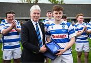 27 April 2025; Aidan Henry of Athy is presented with the Player of the Match award by Leinster Branch president Declan Gardiner after the Bank of Ireland Provincial Towns Cup final match between Athy RFC and County Carlow FC at Forenaughts in Naas, Kildare. Photo by Seb Daly/Sportsfile