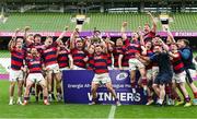 27 April 2025; Dylan Donnellan captain of Clontarf lifts the cup as his team-metes celebrate after the Energia All-Ireland League Men's Division 1A final match between Clontarf and Cork Constitution at the Aviva Stadium in Dublin. Photo by Matt Browne/Sportsfile