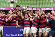 27 April 2025; Dylan Donnellan captain of Clontarf lifts the cup as his team-metes celebrate after the Energia All-Ireland League Men's Division 1A final match between Clontarf and Cork Constitution at the Aviva Stadium in Dublin. Photo by Matt Browne/Sportsfile