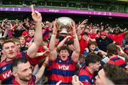 27 April 2025; Oran Walsh of Clontarf lifts the cup as his team-metes celebrate after the Energia All-Ireland League Men's Division 1A final match between Clontarf and Cork Constitution at the Aviva Stadium in Dublin. Photo by Matt Browne/Sportsfile