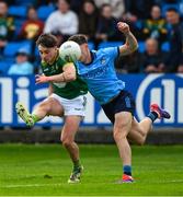 27 April 2025; James Conlon of Meath kicks a first half point, under pressure from David Byrne of Dublin, during the Leinster GAA Football Senior Championship semi-final match between Dublin and Meath at Laois Hire O'Moore Park in Portlaoise, Laois. Photo by Ray McManus/Sportsfile