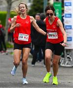 27 April 2025; Eimear Marron of Drogheda & District AC, Louth, takesover from team-mate Mary Leech whilst competing in the women's masters event during the 123.ie National Road Relay Championships in Raheny, Dublin. Photo by Tyler Miller/Sportsfile