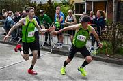 27 April 2025; Sean McCreery of Rathfarnham WSAF AC, Dublin, takes over from team-mate Shane O'Neill whilst competing in the men's 50+ event during the 123.ie National Road Relay Championships in Raheny, Dublin. Photo by Tyler Miller/Sportsfile