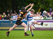 27 April 2025; Darragh Farrell of Athy kicks under pressure from Brian Broderick of County Carlow during the Bank of Ireland Provincial Towns Cup final match between Athy RFC and County Carlow FC at Forenaughts in Naas, Kildare. Photo by Seb Daly/Sportsfile