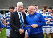 27 April 2025; Leinster Branch president Declan Gardiner presents the Leinster Branch Pennant to Athy RFC 2nds head coach Brian Berry after the Bank of Ireland Provincial Towns Cup final match between Athy RFC and County Carlow FC at Forenaughts in Naas, Kildare. Photo by Seb Daly/Sportsfile