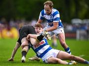 27 April 2025; Ben Crotty of County Carlow is tackled by Aidan Henry of Athy during the Bank of Ireland Provincial Towns Cup final match between Athy RFC and County Carlow FC at Forenaughts in Naas, Kildare. Photo by Seb Daly/Sportsfile
