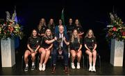 27 April 2025; The Biorra team, including Tara Seguin, Sarah Cooke, Eimear Teehan, Kathy Dermody, Aoife Gilligan, Gráinne Nolan, Aoife Maher, Sarah Teehan and Amy Ryan, representing Offaly and Leinster, are presented with their trophy by Uachtarán Chumann Lúthchleas Gael Jarlath Burns and Cathaoirleach Coiste Náisiúnta Scór Paula Magee after their victory in the Rince Foirne competition during the 2025 Scór Sinsear All-Ireland Finals at the TF Theatre in Castlebar, Mayo. Photo by Shauna Clinton/Sportsfile