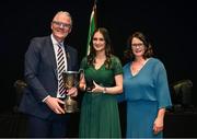 27 April 2025; Leah McNamara, representing Mayo and Connacht, is presented with their trophy by Uachtarán Chumann Lúthchleas Gael Jarlath Burns and Cathaoirleach Coiste Náisiúnta Scór Paula Magee after her victory in the Amhránaíocht Aonair competition during the 2025 Scór Sinsear All-Ireland Finals at the TF Theatre in Castlebar, Mayo. Photo by Shauna Clinton/Sportsfile