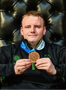 28 April 2025; Joseph 'Joe-Joe' Sheehan of Team Ireland, a member of Mallow Special Olympics Club, Doneraile, Cork, with his bronze medal pictured at the Team Ireland World Winter Games celebration at The Mansion House in Dublin. Photo by Tyler Miller/Sportsfile