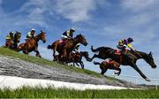 29 April 2025; Runners and riders jump Ruby's Double during The Kildare Hunt Club Cross Country Chase for the Ladies Perpetual Cup on day one of the Punchestown Festival at Punchestown Racecourse in Kildare. Photo by David Fitzgerald/Sportsfile