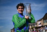 29 April 2025; Jockey Danny Mullins with the trophy after winning The GR1 Dooley Insurance Group Champion Novice Chase onboard Champ Kiely during day one of the Punchestown Festival at Punchestown Racecourse in Kildare. Photo by David Fitzgerald/Sportsfile