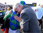 29 April 2025; Jockey Danny Mullins and owner Mick Masterson after winning The GR1 Dooley Insurance Group Champion Novice Chase with Champ Kiely during day one of the Punchestown Festival at Punchestown Racecourse in Kildare. Photo by David Fitzgerald/Sportsfile