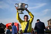 29 April 2025; Jockey Sean Flanagan celebrates with the trophy after winning The William Hill Champion Chase on Marine Nationale on day one of the Punchestown Festival at Punchestown Racecourse in Kildare. Photo by David Fitzgerald/Sportsfile