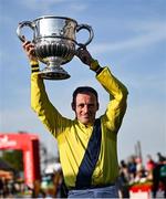 29 April 2025; Jockey Sean Flanagan celebrates with the trophy after winning The William Hill Champion Chase on Marine Nationale on day one of the Punchestown Festival at Punchestown Racecourse in Kildare. Photo by David Fitzgerald/Sportsfile