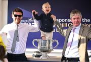 29 April 2025; Winning trainer Barry Connell, right, celebrates with the trophy and his family, including son, Rory, left, and grandson, Jack, aged three, centre, after winning The William Hill Champion Chase with Marine Nationale on day one of the Punchestown Festival at Punchestown Racecourse in Kildare. Photo by David Fitzgerald/Sportsfile