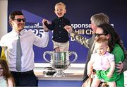 29 April 2025; Winning trainer Barry Connell, right, celebrates with the trophy and his family, including son, Rory, left, and grandson, Jack, aged three, centre, after winning The William Hill Champion Chase with Marine Nationale on day one of the Punchestown Festival at Punchestown Racecourse in Kildare. Photo by David Fitzgerald/Sportsfile