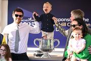 29 April 2025; Winning trainer Barry Connell, right, celebrates with the trophy and his family, including son, Rory, left, and grandson, Jack, aged three, centre, after winning The William Hill Champion Chase with Marine Nationale on day one of the Punchestown Festival at Punchestown Racecourse in Kildare. Photo by David Fitzgerald/Sportsfile