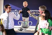 29 April 2025; Winning trainer Barry Connell, right, celebrates with the trophy and his family, including son, Rory, left, and grandson, Jack, aged three, centre, after winning The William Hill Champion Chase with Marine Nationale on day one of the Punchestown Festival at Punchestown Racecourse in Kildare. Photo by David Fitzgerald/Sportsfile
