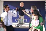 29 April 2025; Winning trainer Barry Connell, right, celebrates with the trophy and his family, including son, Rory, left, and grandson, Jack, aged three, centre, after winning The William Hill Champion Chase with Marine Nationale on day one of the Punchestown Festival at Punchestown Racecourse in Kildare. Photo by David Fitzgerald/Sportsfile