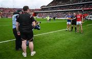 27 April 2025; Team captains Ronan Maher of Tipperary, left, and Robert Downey of Cork shake hands in the company of referee Johnny Murphy before the Munster GAA Hurling Senior Championship Round 2 match between Cork and Tipperary at SuperValu Páirc Uí Chaoimh in Cork. Photo by Brendan Moran/Sportsfile