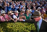 30 April 2025; Trainer Willie Mullins is congratulated by spectators after winning the Ladbrokes Punchestown Gold Cup Chase with Galopin Des Champs on day two of the Punchestown Festival at Punchestown Racecourse in Kildare. Photo by David Fitzgerald/Sportsfile
