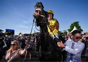 30 April 2025; Paul Townend returns to the parade ring on Galopin Des Champs, along with owner Audrey Turley and groom Adam Connolly, after winning the Ladbrokes Punchestown Gold Cup Chase on day two of the Punchestown Festival at Punchestown Racecourse in Kildare. Photo by David Fitzgerald/Sportsfile