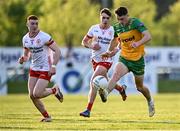 30 April 2025; Kevin Muldoon of Donegal gets away from Tyrone players Conor O'Neill and Callum Daly, left, during the Dalata Hotel Group Ulster GAA Football U20 Championship final match between Donegal and Tyrone at Owenbeg Derry GAA Centre in Dungiven, Derry. Photo by Piaras Ó Mídheach/Sportsfile