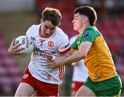 30 April 2025; Ben Hughes of Tyrone in action against Seanan Carr of Donegal during the Dalata Hotel Group Ulster GAA Football U20 Championship final match between Donegal and Tyrone at Owenbeg Derry GAA Centre in Dungiven, Derry. Photo by Piaras Ó Mídheach/Sportsfile