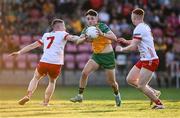30 April 2025; Conor McGinty of Donegal in action against Caolan Donnelly, left, and Callum Daly of Tyrone during the Dalata Hotel Group Ulster GAA Football U20 Championship final match between Donegal and Tyrone at Owenbeg Derry GAA Centre in Dungiven, Derry. Photo by Piaras Ó Mídheach/Sportsfile